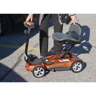 An Elder Ready to Ride a Jupiter Gold Auto Fold Transport 4AF Mobility Scooter